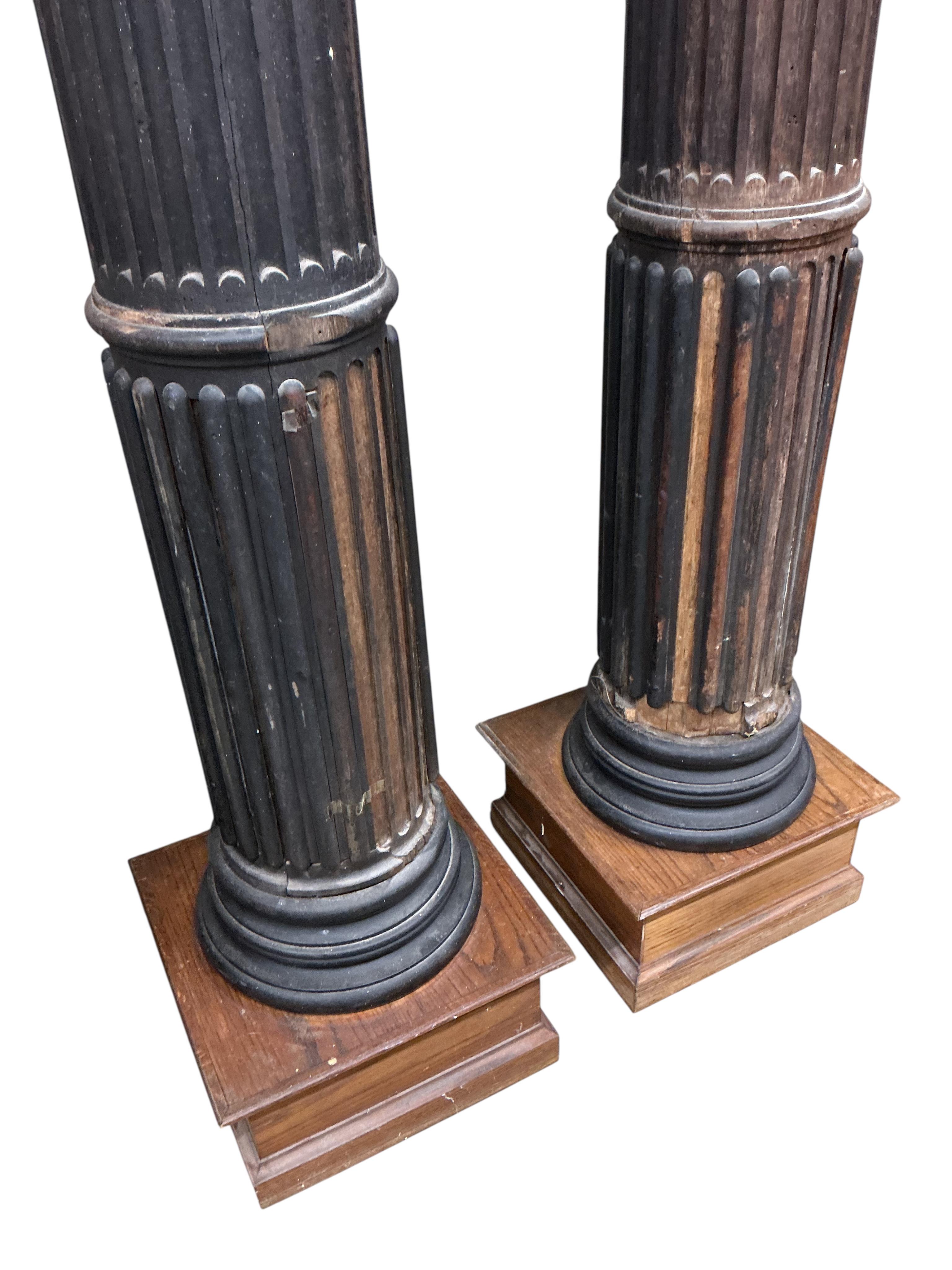 A pair of 17th century oak Corinthian columns, of large size, height 279cm, by repute from St Mary le Bow, designed by Christopher Wren